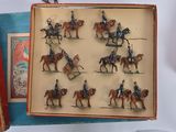 many figurines of men riding horses in a box