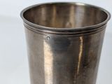 a silver cup that is sitting on a table