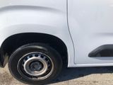 a white van that has a flat tire on the side of the road