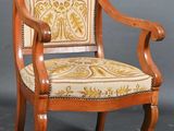 a wooden chair with a yellow and white upholstered seat
