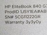 a close up of the back of a laptop computer with a warrant label on it