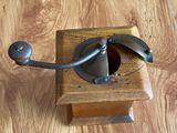 a wooden box with a metal handle on a table