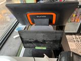 a black and orange pos machine sitting on a counter