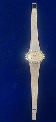 an image of a watch on a blue surface