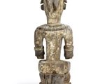 an old wooden statue of a man with a hat on his head