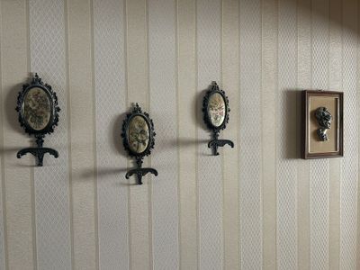 three clocks hanging on the wall in a room