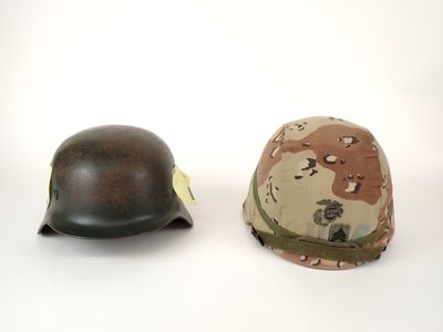 two helmets are sitting next to each other on a white surface