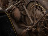 a close up of an old motorcycle that has been rusted