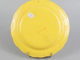 underside view of a yellow plate showing the base of the plate