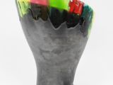 a black vase with a multicolored design on it