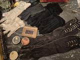 many gloves, a picture frame, a picture, and a picture on the floor