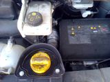 a close up of a car engine with a yellow light