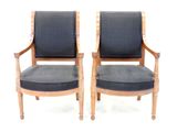 pair of mid century style chairs with black upholstered cushions