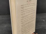 the book is open on a black surface with a black background