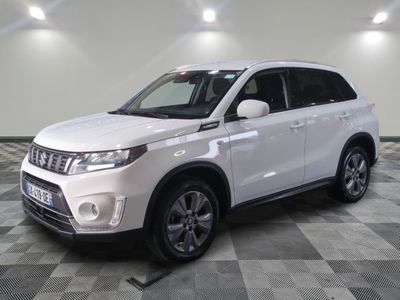 the white suv is parked on a checkered tile floor