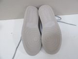 pair of white shoes with grey laces on a white surface