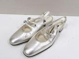 silver leather shoes with buckles on the toes and heel