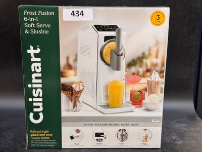 emballage d'une boîte sur laquelle figure l'image d'un extracteur de jus