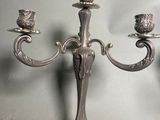 a silver candelab with three candles on it