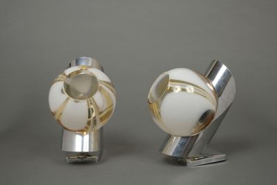 two silver and white knobs on a gray surface