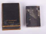 two old books are sitting next to each other on a white surface