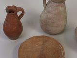 four different types of pottery displayed on a white surface