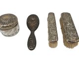 three silverware items including a brush, spoon, and a jar