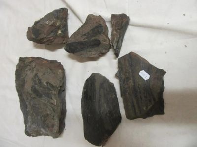several pieces of rock are sitting on a white cloth