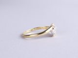 a gold ring with a single diamond on top of it