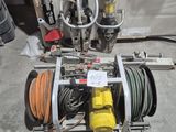a machine that is sitting on the ground next to a hose