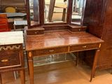 a wooden desk with a mirror on top of it