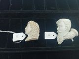 two busts of men and a price tag on a shelf
