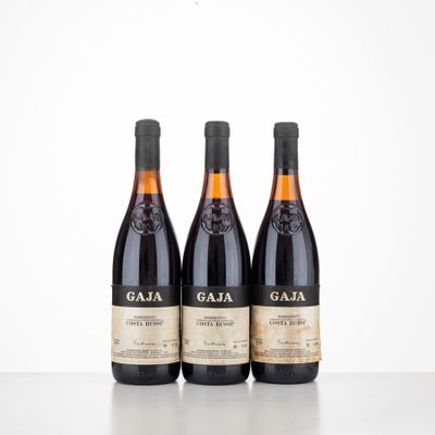 three bottles of wine sit on a table in front of a white background