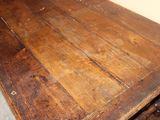 a wooden table with wheels on it in a room