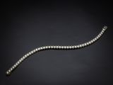 un bracelet en diamants et en or blanc, créé par un homme d'affaires