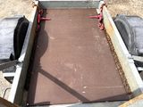 a metal box with a chain attached to it that is sitting on the ground