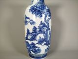a large blue and white vase with a tree on it