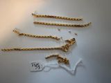 a close up of a bunch of gold chains on a table