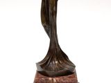 bronze statue of a woman holding a vase on a marble base