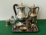 a tray with silverware on it on a green table