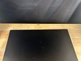 a laptop computer sitting on top of a wooden table