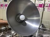 many pots and pans in a metal rack in a kitchen