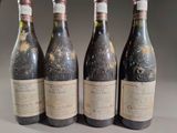 four bottles of wine are lined up on a table