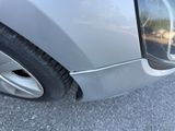 a close up of a car ' s front bumper with a broken tire