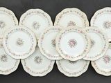 many plates that are stacked together on a table