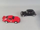 three toy cars sitting next to each other on a white surface