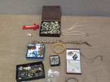 a lot of jewelry sitting on a table next to a wall