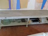 a white table with a wooden top in a living room