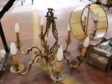 a chandelier with five lights on it in a room