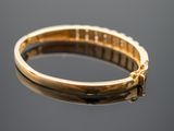 an image of a close up of a gold ring on a reflective surface